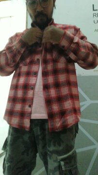 Man in Plaid Shirt Relaxing Indoors.