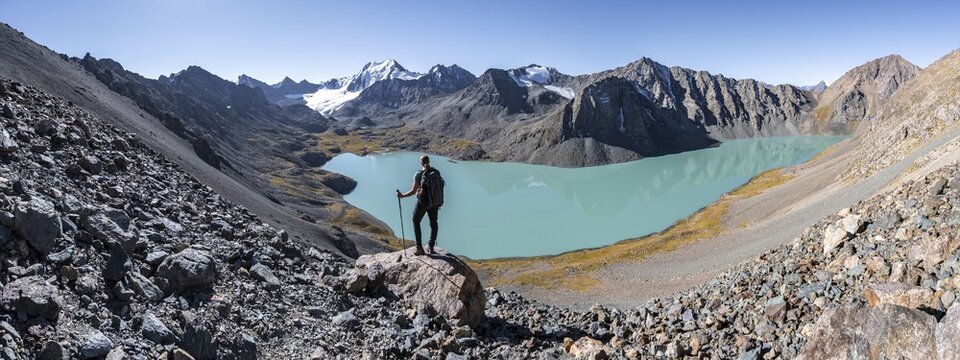 Trekking, hiker in the Tien Shan high mountains, mountain lake Ala-Kul Lake, 4000 metre peak with glacier, Ak-Su, Kyrgyzstan