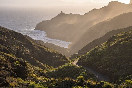 View of Punta San Lorenzo, Punta Sabina and the road to Playa de La Caleta. In the morning, good weather, mist rising in the valleys. La Gomera, Canary Islands, Spain