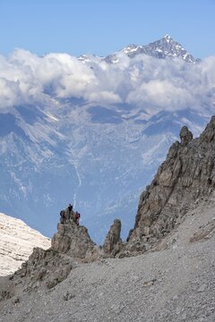 View through a flock of Cima Presanella, hikers on the Via Ferrate Benini via ferrata, Brenta Mountains, Brenta-Adamello Natural Park, Trentino, Italy