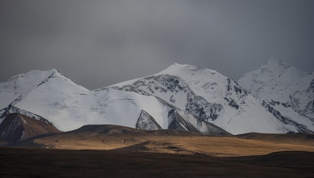 Glaciated and snow-capped mountains, dramatic landscape, high plateau, autumnal mountain landscape with yellow grass, Tian Shan, Sky Mountains, Sary Jaz Valley, Kyrgyzstan