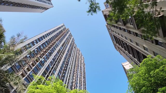 low angle shot of high rise residential apartment buildings under clear blue sky