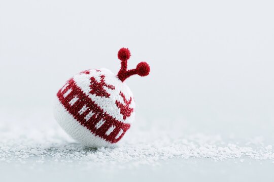 Small winter hat on a snowy surface during the cold season