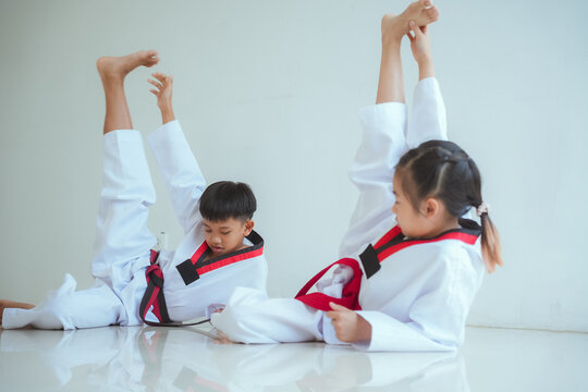 Kids practice taekwondo moves in training session at a martial arts dojo during afternoon class