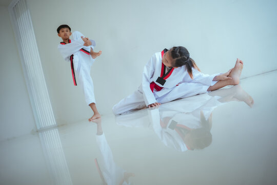 Kids practice taekwondo moves in training session at a martial arts dojo during afternoon class