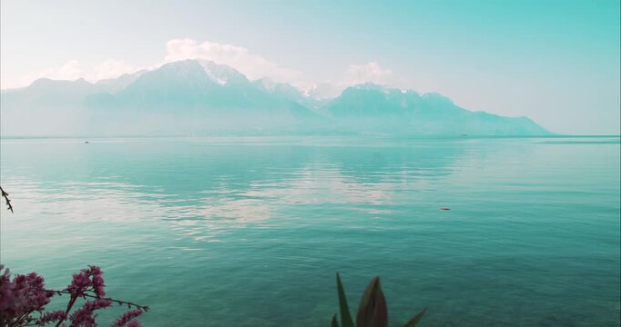 Panoramic View Across Lake Geneva Towards the Swiss Alps - Wide scenic view across the calm waters of Lake Geneva with the Swiss Alps rising in the distance. Peaceful landscape captured near Montreux