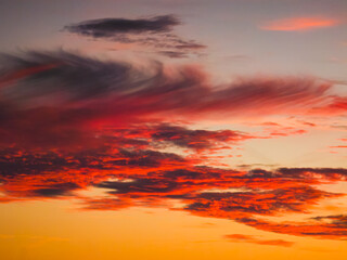 Fototapeta premium Spectacular red and orange sunset clouds above SETE, France. Vibrant evening colors create a dramatic sky and atmospheric Mediterranean landscape.