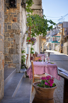 Tables of a restaurant in the streets of Tzermiadon on the Lasithi high plateau on the island Crete, Greece.