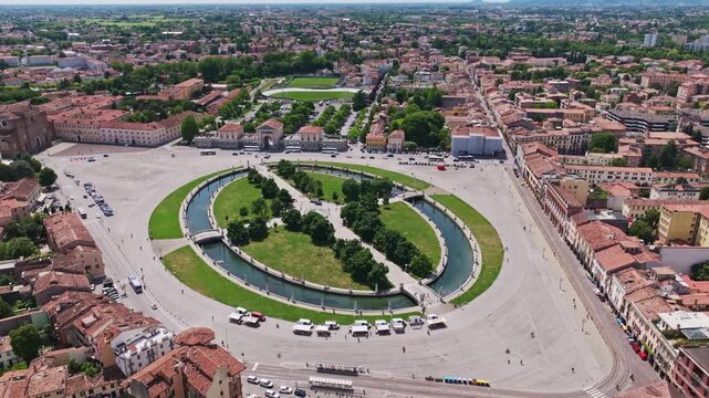 Aerial drone view of Prato della Valle in Padua (Padova), Italy, showcasing the iconic elliptical square, surrounding statues, canals, and historic architecture in Veneto