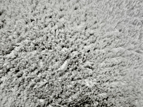 plush gray wool rug texture reveals soft organic pile details in minimalist overhead interior composition