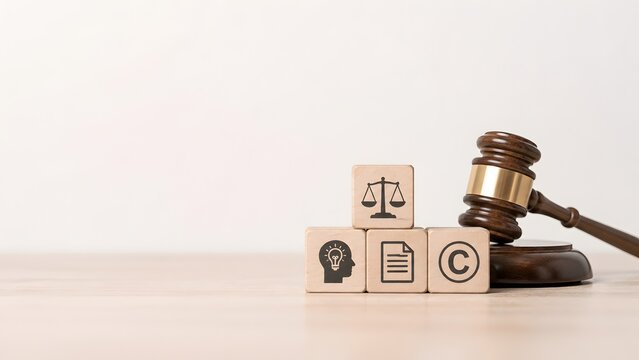 Legal foundation for intellectual property concept featuring copyright document and justice icons on blocks with court gavel