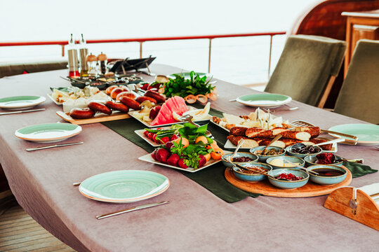 traditional turkish breakfast feast with rich variety on table served on boat gulette for holiday tourists