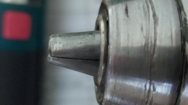 Extreme close-up of a metal drill chuck mechanism rotating