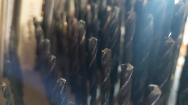 Close-up panning shot of twist drill bits organizer set, workshop tools