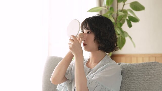 鏡を見ながら前髪を整える女性, Woman Adjusting Her Bangs While Looking in a Mirror