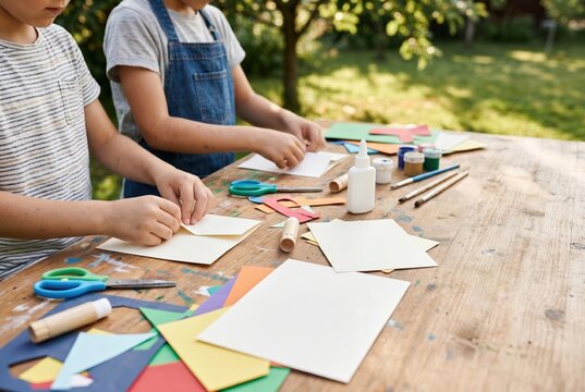 Children making crafts at outdoor art table