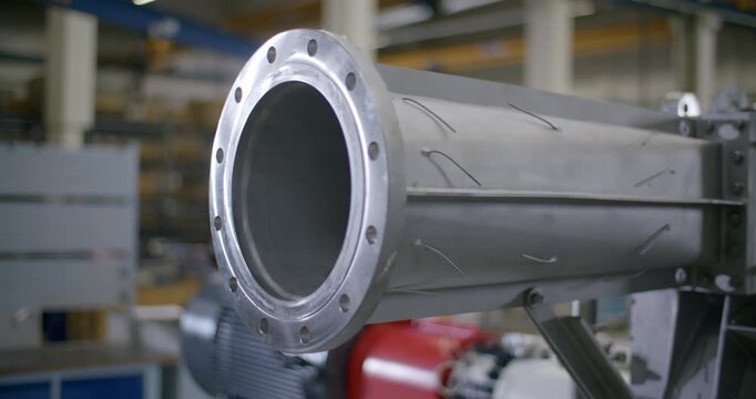 Side view of a large metallic industrial pipe component with flange assembly