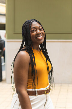 Woman smiling with box braids outdoors