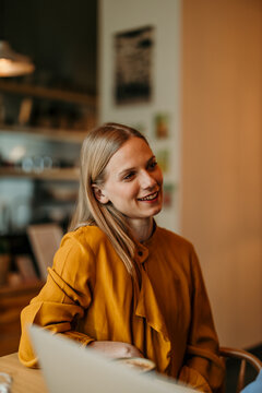 Young woman smiling while sitting in a cafe