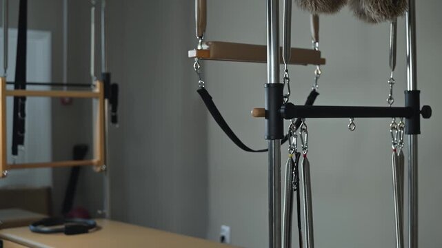 A fitness training area showcases various hanging tools and straps attached to a wall-mounted system