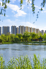 Urban Lakeside Park with High-Rise Apartments © TranAnhDao