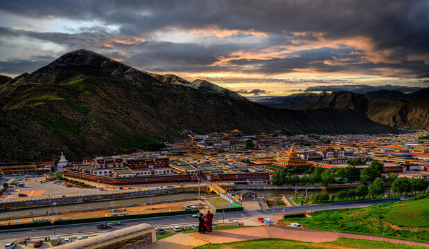 Tibetan Monastery Town Beneath Dramatic Mountain Sunset