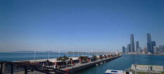 Obraz premium Qingdao waterfront skyline with modern skyscrapers and pier