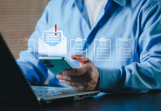 Business professional checking tax notification email on smartphone with digital tax forms interface. Concept of online taxation, compliance, financial management, and electronic filing.