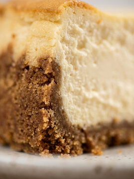 Slice of classic baked New York cheesecake texture closeup