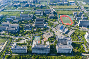 Aerial view of modern university campus with sports field and green parkland © PhungBao