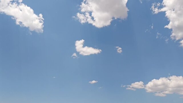 Clouds moving in the brilliant sky at midday