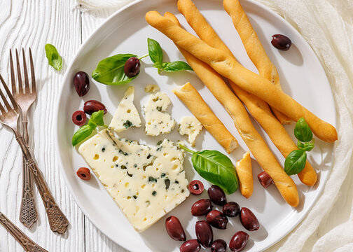 Italian blue cheese platter with grissini and olives