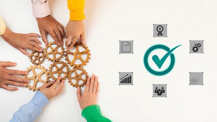 Obraz premium Collaborative Hands Placing Gears on Table with Icons Representing Success, Strategy, Teamwork, and Project Management for Business Concept Gluon.