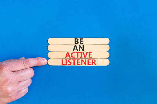 Be an active listener words symbol. Concept words Be an active listener on beautiful wooden sticks. Beautiful blue background. Businessman hand. Business be an active listener concept. Copy space.