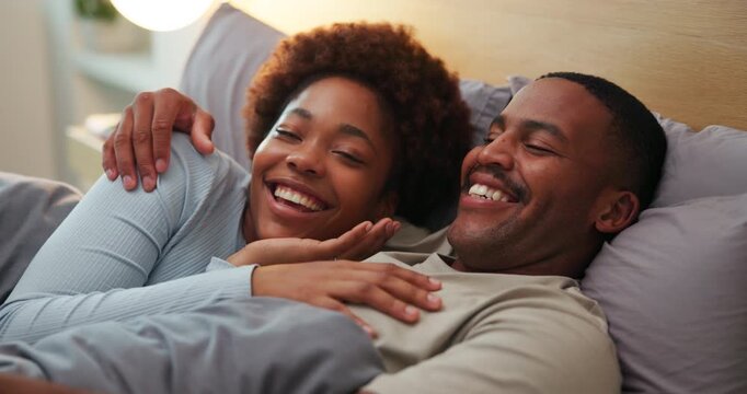 Laugh, relax and black couple on bed in home for bonding, talking or joke together on weekend. Happy, conversation and man with woman in bedroom for connection, cuddle and love in marriage in house.