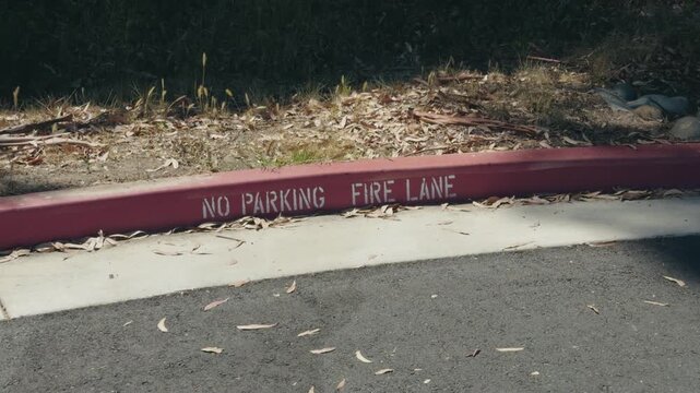 No parking fire lane warning on a red curb