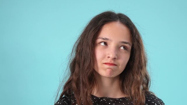 Annoyed young woman rolling her eyes and showing signs of boredom