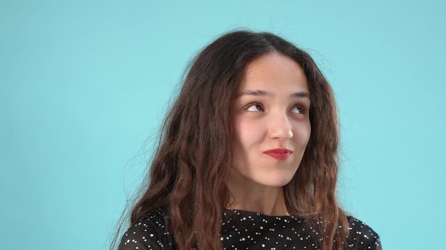 Young brunette woman pulling a funny face sticking her tongue out