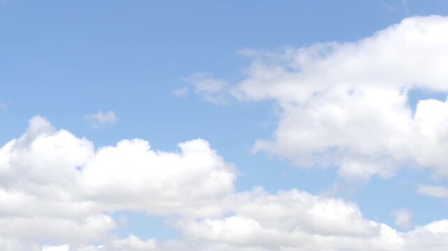 White and brilliant big clouds moving at midday