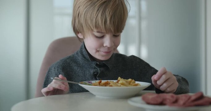 Kid Boy Eat Fried Potato. Eating Breakfast Lunch in Kitchen. 4K 10-bit
