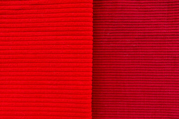 Fototapeta premium Red and burgundy corduroy fabrics comparison showing fine and wide wale textures