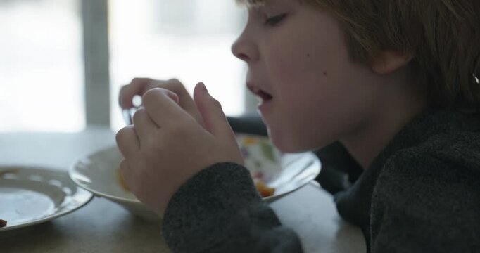 Kid Boy Eat Fried Potato. Eating Breakfast Lunch in Kitchen. 4K 10-bit