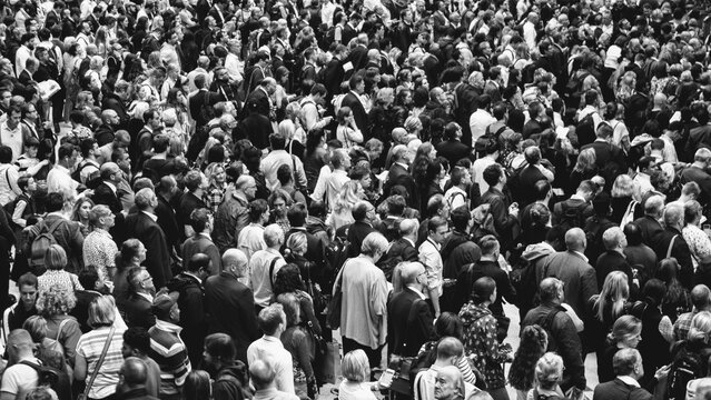 Crowded public space, busy people in a crowd, black and white photo