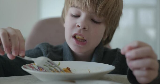 Kid Boy Eat Fried Potato. Eating Breakfast Lunch in Kitchen. 4K 10-bit