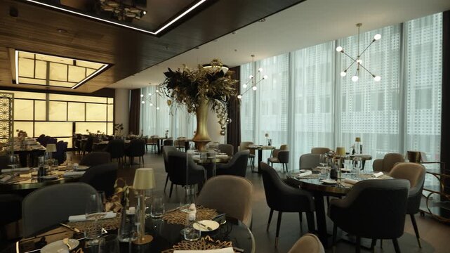 Stylish hotel dining room with elegant tables and large glass window