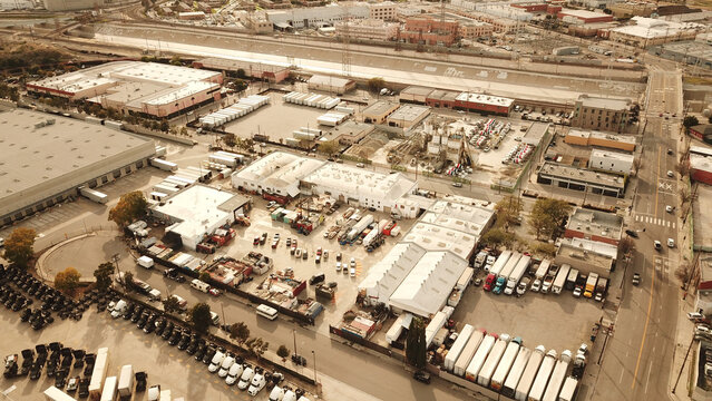 Aerial view of Big Art Labs industrial facility with warehouses, parked trucks, and shipping containers in an urban setting Los Angeles, California, United States.