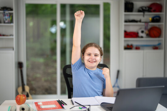 Child learning at home with laptop and books. Kid learning in a cozy home classroom. Kid learning homework. Online learning. Education concept. Child tutoring at home. Boy doing schoolwork.