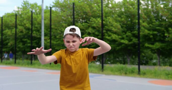 Young boy reacts emotionally after missed basketball shot on outdoor court. Frustration and disappointment lead to angry bounce of the ball, capturing real childhood emotions and challenges