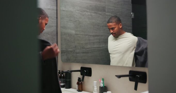 Mirror, man and take off robe for grooming, morning routine and walking in bathroom for preparation. Reflection, home and black person remove gown for self care, hygiene or getting ready to start day