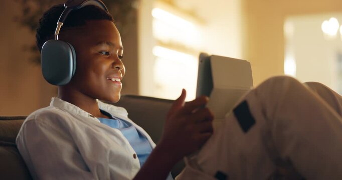 Headphones, tablet and black child in home with video call, communication or waving for online gaming. Relax, talking and boy on sofa for virtual conversation for game on app with digital technology.